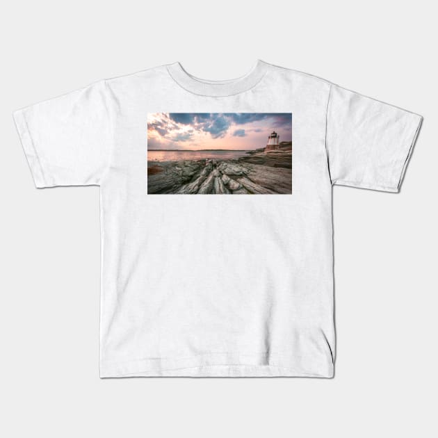 Lighthouse on a rocky beach Kids T-Shirt by jswolfphoto